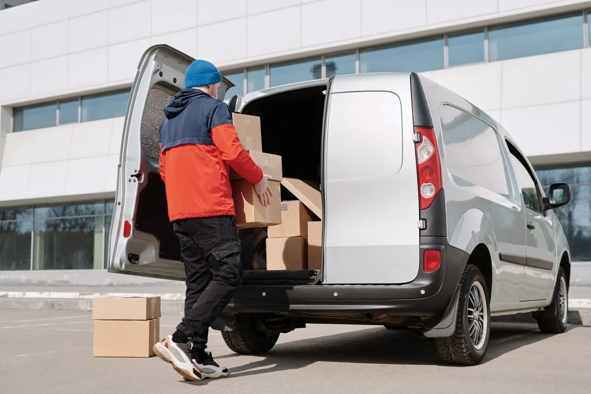 Delivery driver loading packages — representing one of the many industries served by Yevs Tax & Accounting Solutions