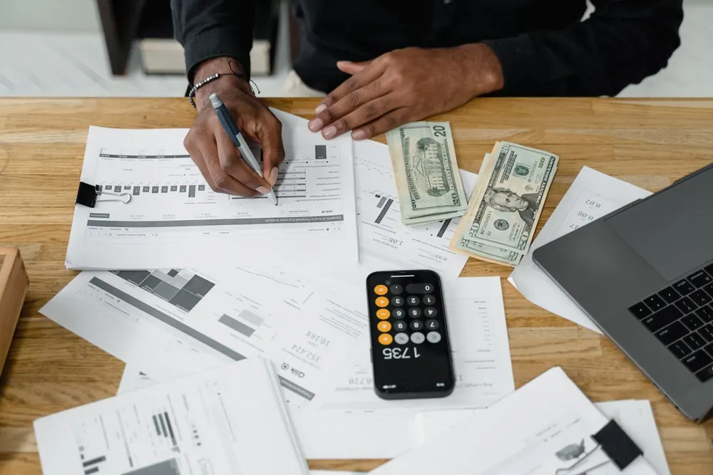 Tax advisor reviewing financial statements and tax documents with a client