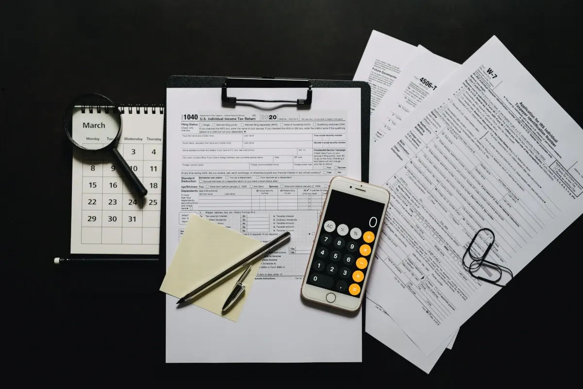 Tax documents, calendar and calculator laid out for year-round planning